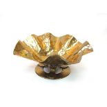 A trench art brass frilled planished bowl of Arts and Crafts influence