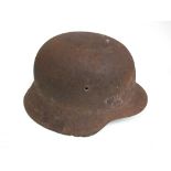 A WWII German relic helmet reputedly found in a German trench in Normandy,