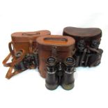 Three pairs of WWI era and later binoculars together with leather cases