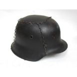 A German design single decal army helmet with camouflage wire cover,