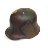 A WWI style German design camouflage helmet with liner