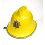 Two mid 20th Century British Fire Service helmets, yellow in colour,