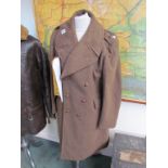 A WWII Army officer's Great Coat dated 1943, size 8, with captain's badges,