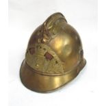 A French fireman's helmet in brass with liner and chinstrap