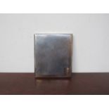 A silver cigarette case with engine turned design, rose gold surround, London 1934,