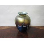 An Okra iridescent glass vase in blue and gold, etched details to base,