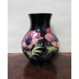 A Walter Moorcroft 'Anemone' design vase of bulbous form, marked as a second,