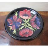 A Walter Moorcroft 'Anemone' design plate 26½ cm