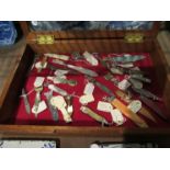 A display case containing a collection of book marks and penknives.