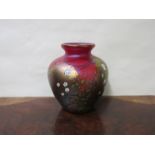 An Okra iridescent glass vase of bulbous form decorated with flowers, red,