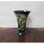 A modern Moorcroft vase decorated in the Strawberry plant and butterfly pattern, marks to base,