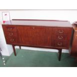 A 1960's side cabinet with single fall front cabinet door flanked by six drawers.