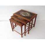 A nest of three mid 20th Century tile topped teak tables