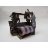 A Studio pottery sculpture of two men on a loom.