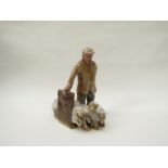 A Studio pottery sculpture of a man and sheep.