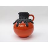 A Roth Keramik orange glaze jug with thick black lava over glaze, labelled 18.