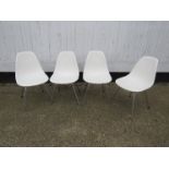 Charles & Ray Eames - A set of four Vitra white dining chairs on chromed legs,