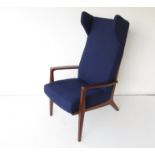 A Danish mahogany framed wing back lounge chair, recently upholstered in navy blue wool.