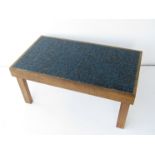 A blue tiled oak coffee table.