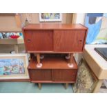 A pair of Danish teak small side cabinets on turned teak legs.