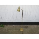A brassed standard lamp with adjustable single spot