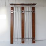 A wood and metal wall hanging coat rack.