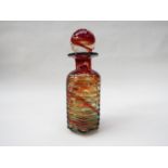 A Mdina glass bottle and stopper in mottled orange/red with blue rib trailing 26cm high