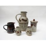 Collection of four studio pottery jugs and a lidded jar in the David Leach style.