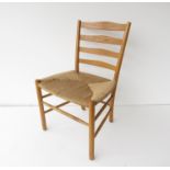 A Danish teak dining chair with seagrass seat designed by Kaare Klint for Fritz Hansen.