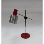 An aluminium red painted metal adjustable desk lamp