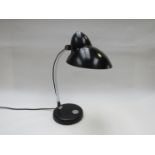 A black painted metal adjustable desk lamp with chromed metal arm