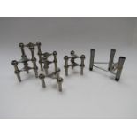 A collection of Nagel Candle holders and a stainless steel candleabrum