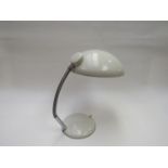 A cream painted metal adjustable desk lamp