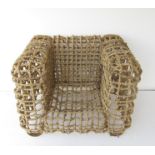 A metal rod and cane weaved cube chair by Kenneth Cobonpue 103cm x 88cm x 80cm