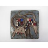 A Continental pottery tile with relief moulded bull in mosaic and glazed in colours, 15.5cm x 15.