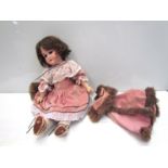 A bisque head Armand Marseille girl doll in pink dress