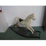 A painted wooden rocking horse on bow rocker