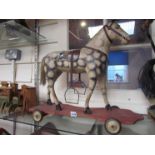 A 19th Century wooden dapple horse on wheeled base