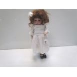 A bisque head, composition body girl doll, 42cms,