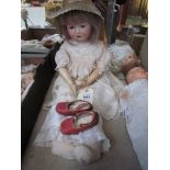 A bisque head, composition body girl doll,