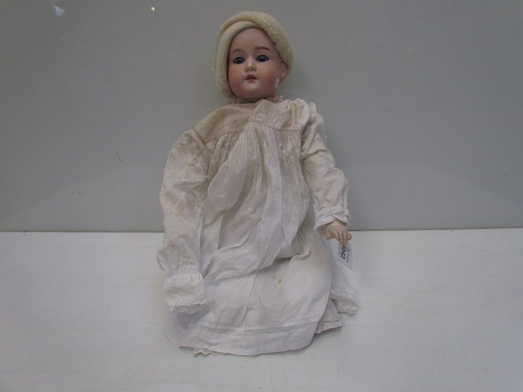 A bisque head, kid and composition body doll, lower legs missing,