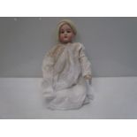 A bisque head, kid and composition body doll, lower legs missing,