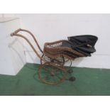 An Edwardian wicker dolls pram,