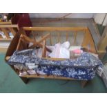 A wooden dolls cot,