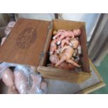 A cigar box containing a quantity of miniature plastic dolls