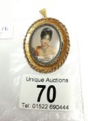 A hand painted miniature profile of a young lady with diamonds in her necklace, hair and ears,