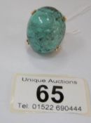 A large 18ct gold turquoise set ring of ovate form in chased gold mount, circa 1970,