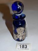 A blue glass scent bottle with hall marked silver decoration