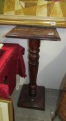 A mahogany torchere with reeded column