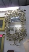 A wrought metal decorative mirror with lights